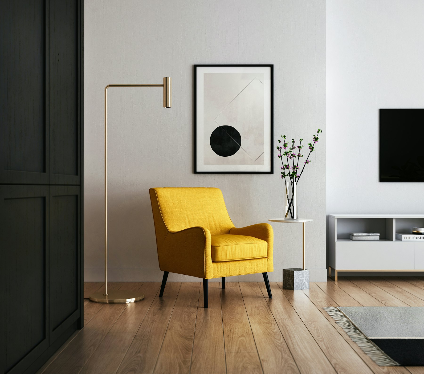 A bright, simply furnished room with a yellow armchair, a floor lamp, and a vase of branches